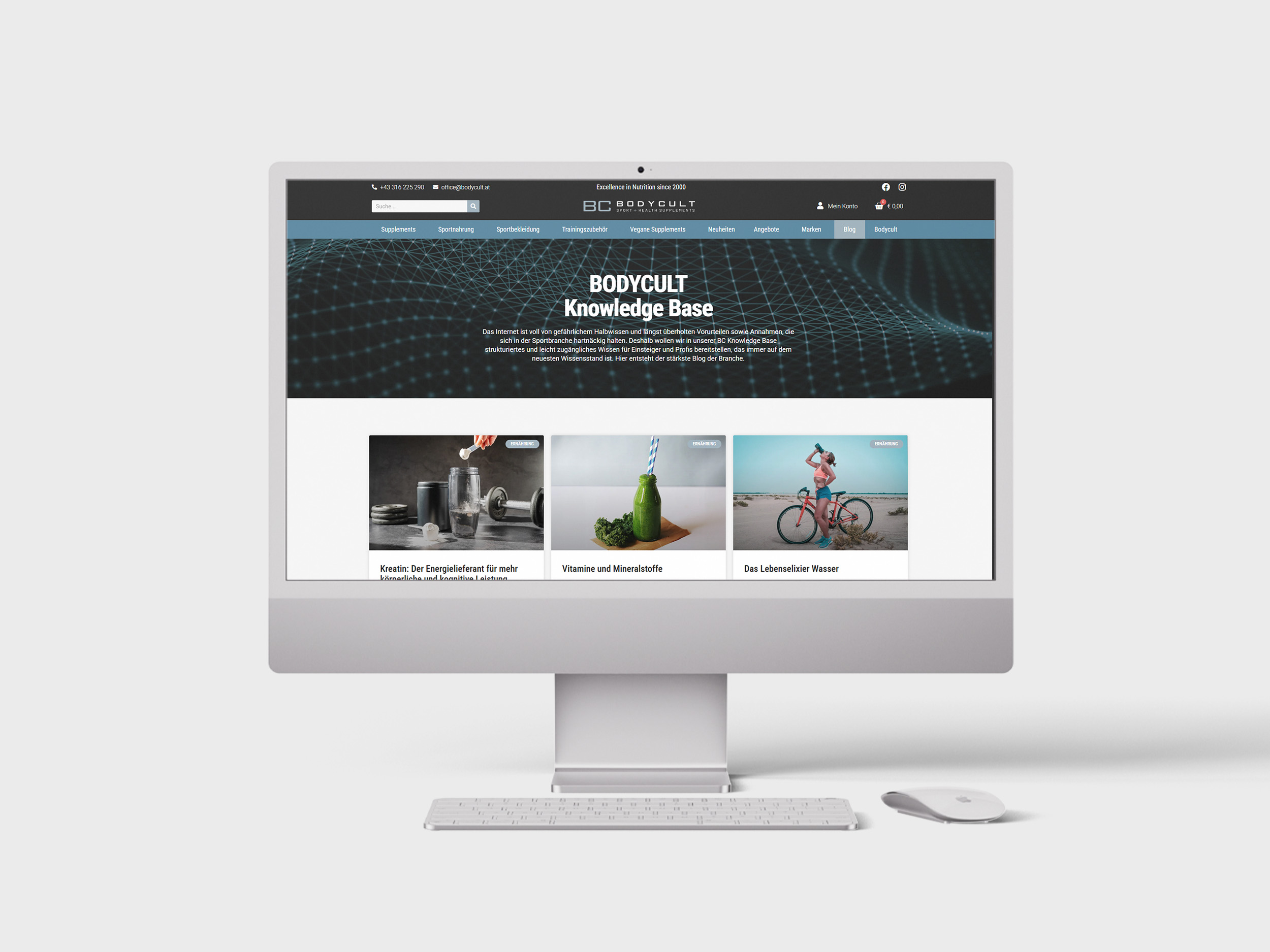 Ein Apple Mac, auf dessen Bildschirm ein Teil der Bodycult-Startseite zu sehen ist - die Knowledge Base mit den Blogartikeln