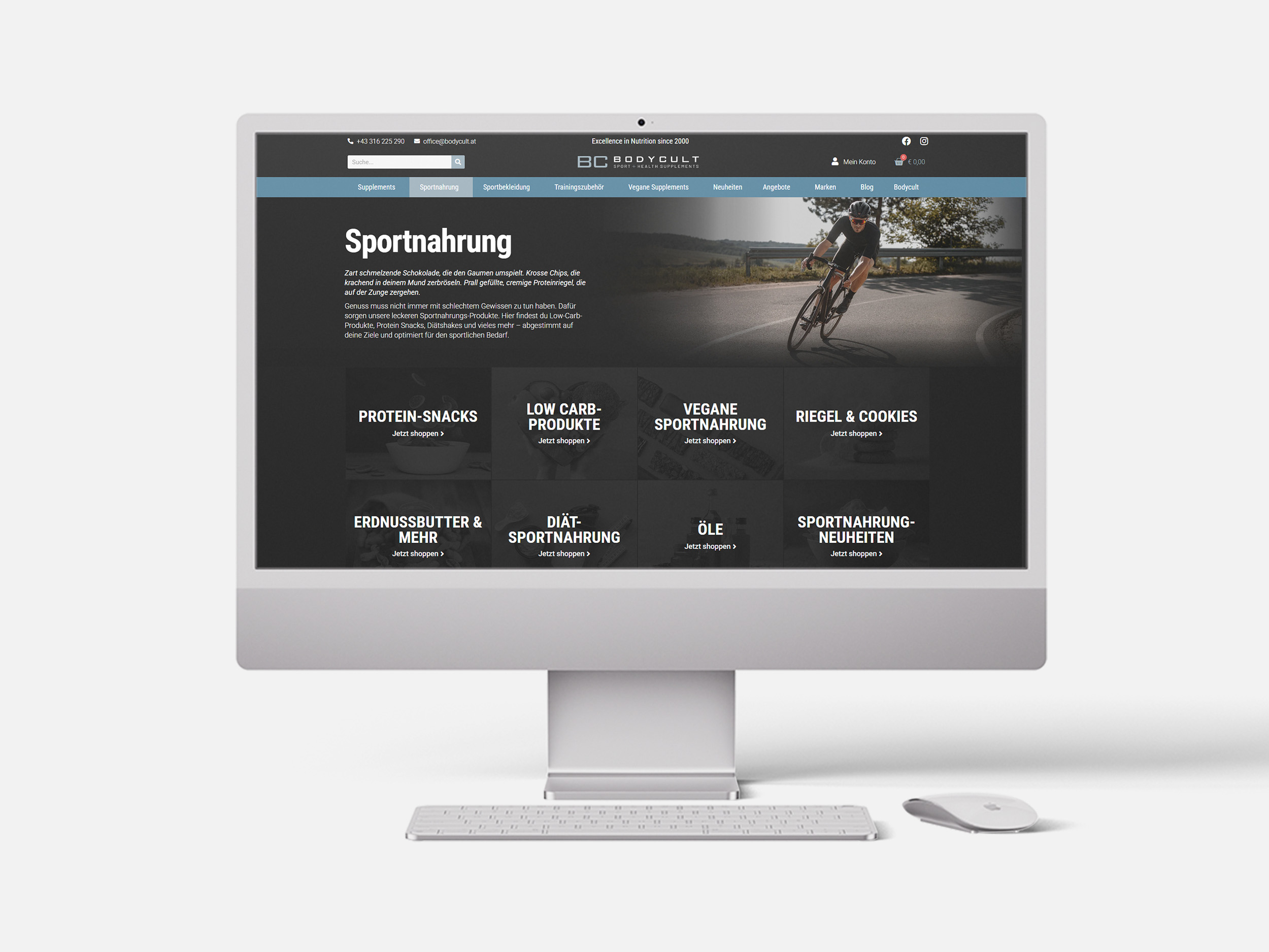 Ein Apple Mac, auf dessen Bildschirm eine Unterseite des Bodycult-Webshops zu sehen ist - die Sportnahrungsseite